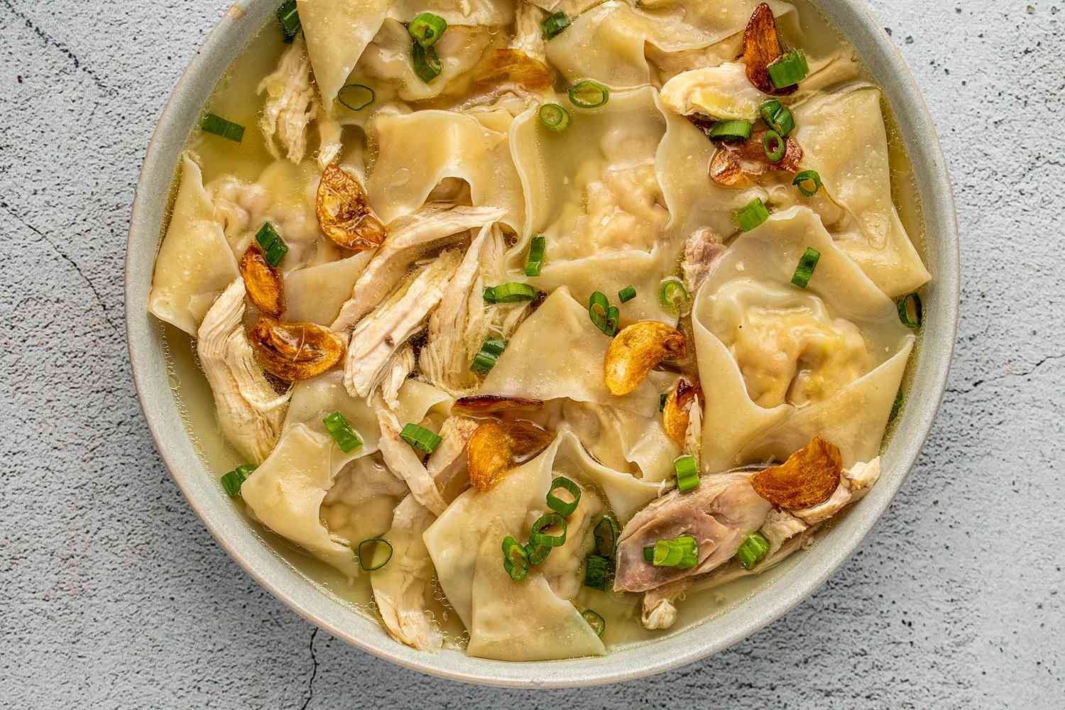 Close-up of Pancit Molo, a traditional Filipino dumpling soup from Iloilo, featuring wonton-like dumplings in a savory broth.